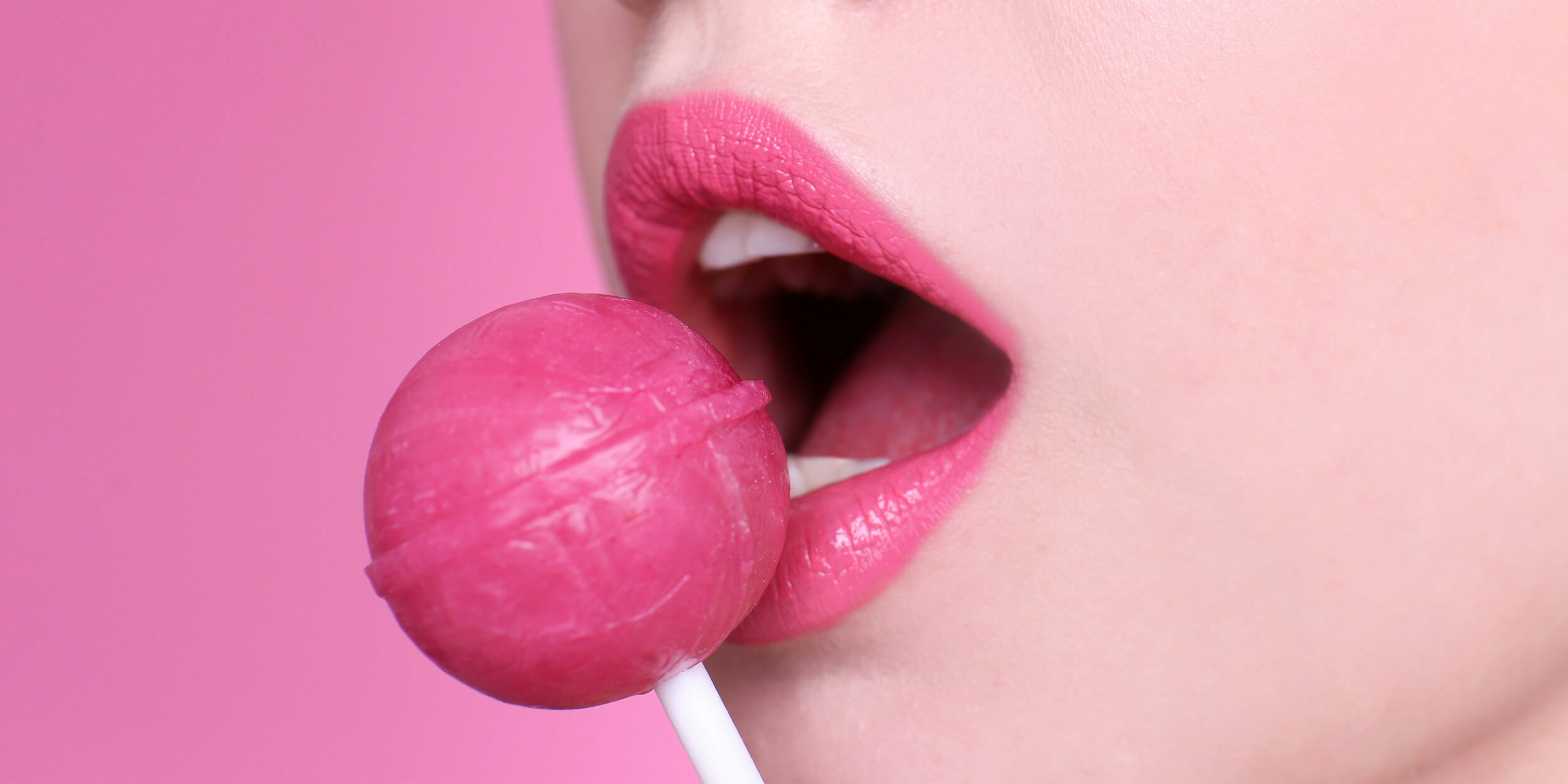 woman seductively eating a lollipop