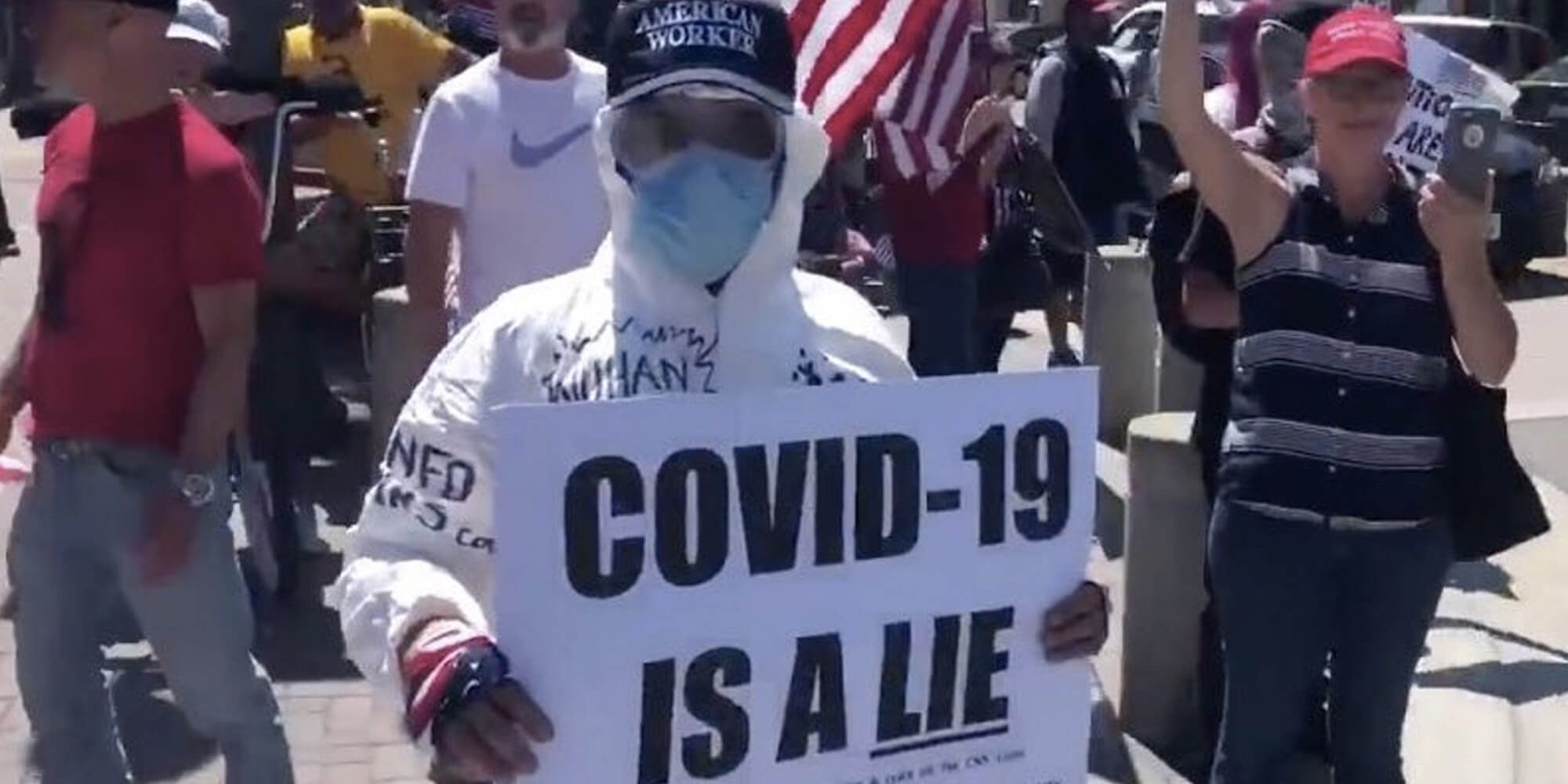 Protester Wearing Protective Gear Spotted With 'COVID19 Is a Lie' Sign
