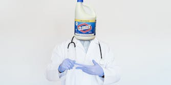 doctor with a bottle of clorox bleach for a head