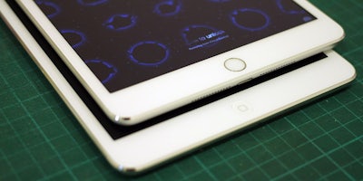 two white iPad minis on a table