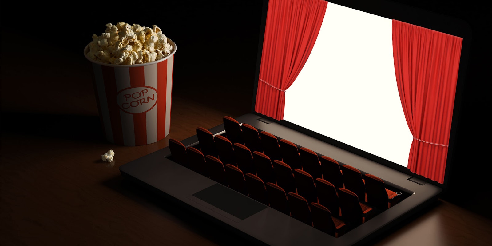 movie theater seats in place of keyboard on laptop, screen has red curtains opening