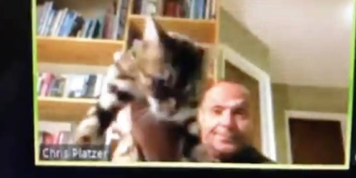 Chris Platzer holding up his cat during a zoom meeting