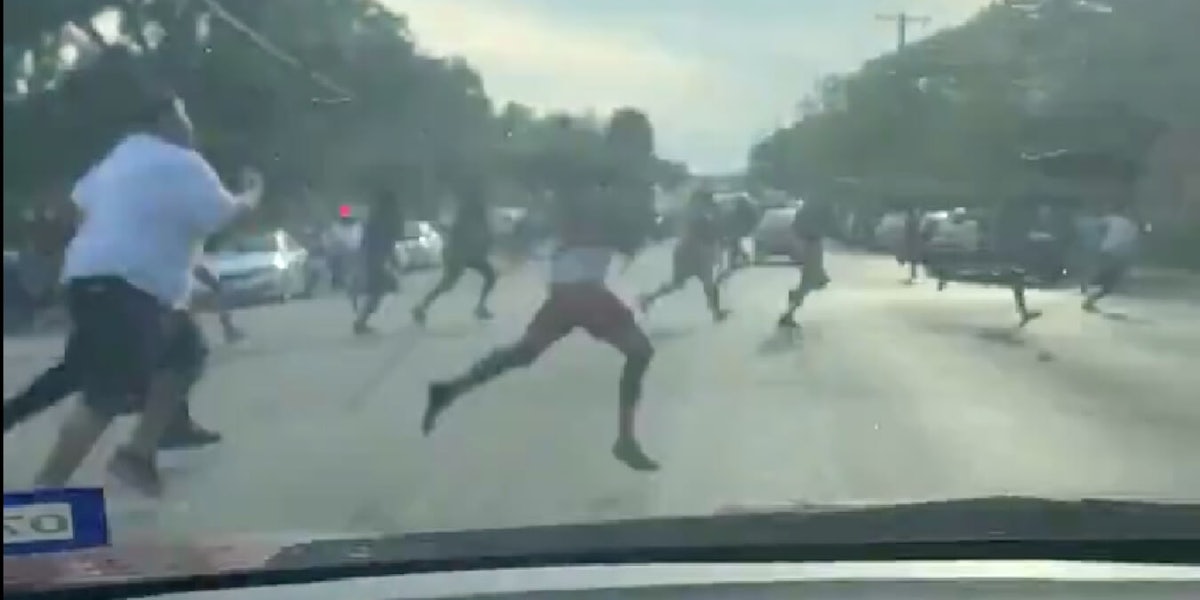 Video shows people running across the street to run from gunshots