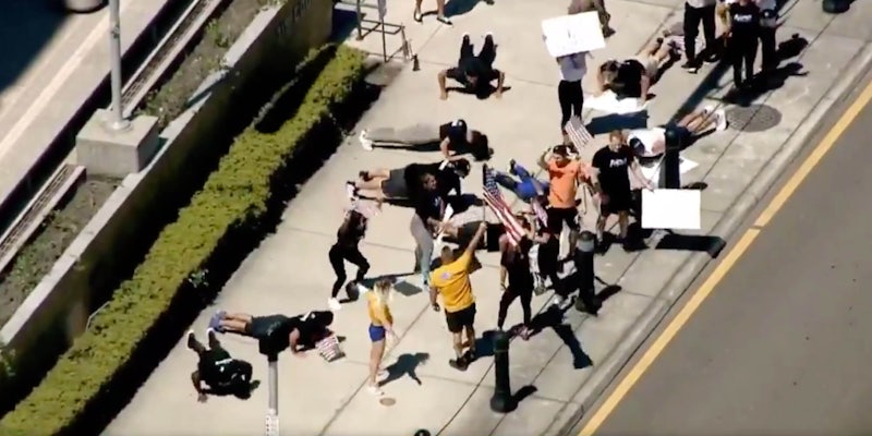 A group of protesters doing push-ups and squats