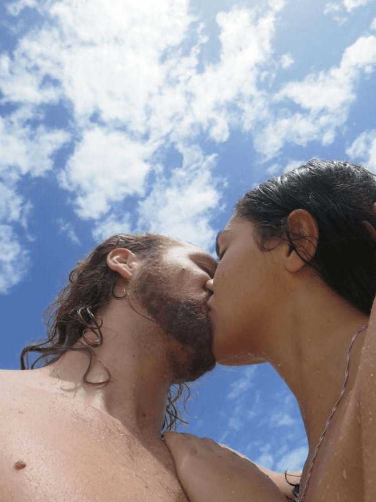 Image of couple kissing under the blue sky