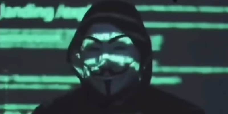 A person in a Guy Fawkes Anonymous mask