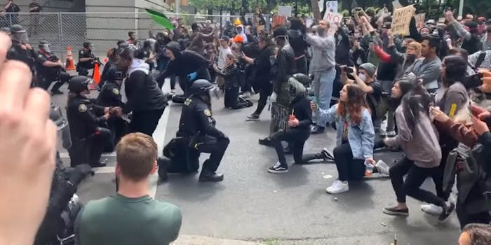 portland police kneel with protesters