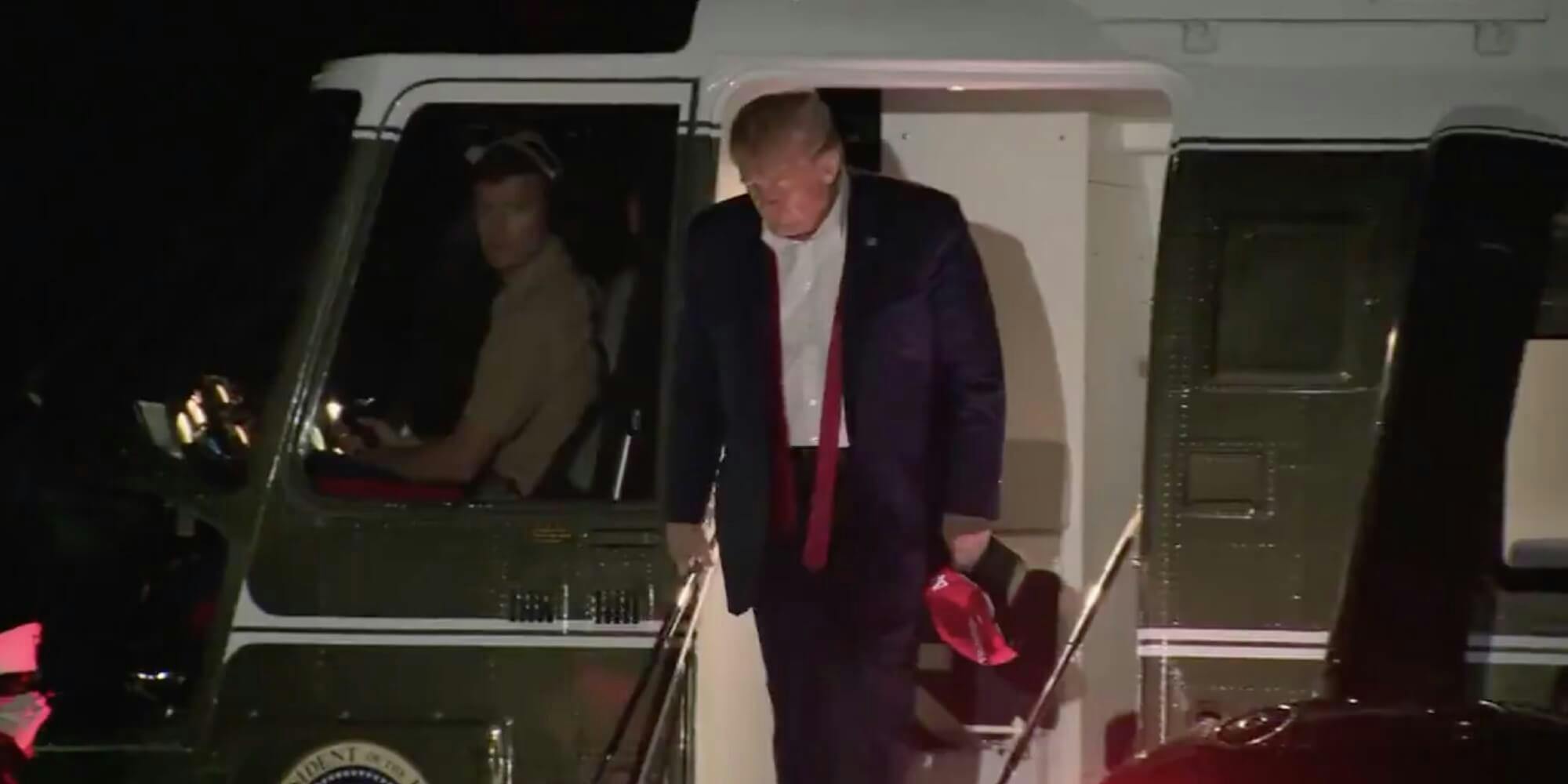 Trump leaving Marine One with his tie untied
