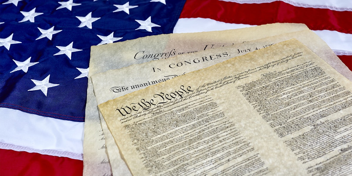 US Constitution and Declaration of Independence on American flag