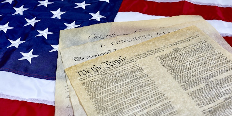 US Constitution and Declaration of Independence on American flag