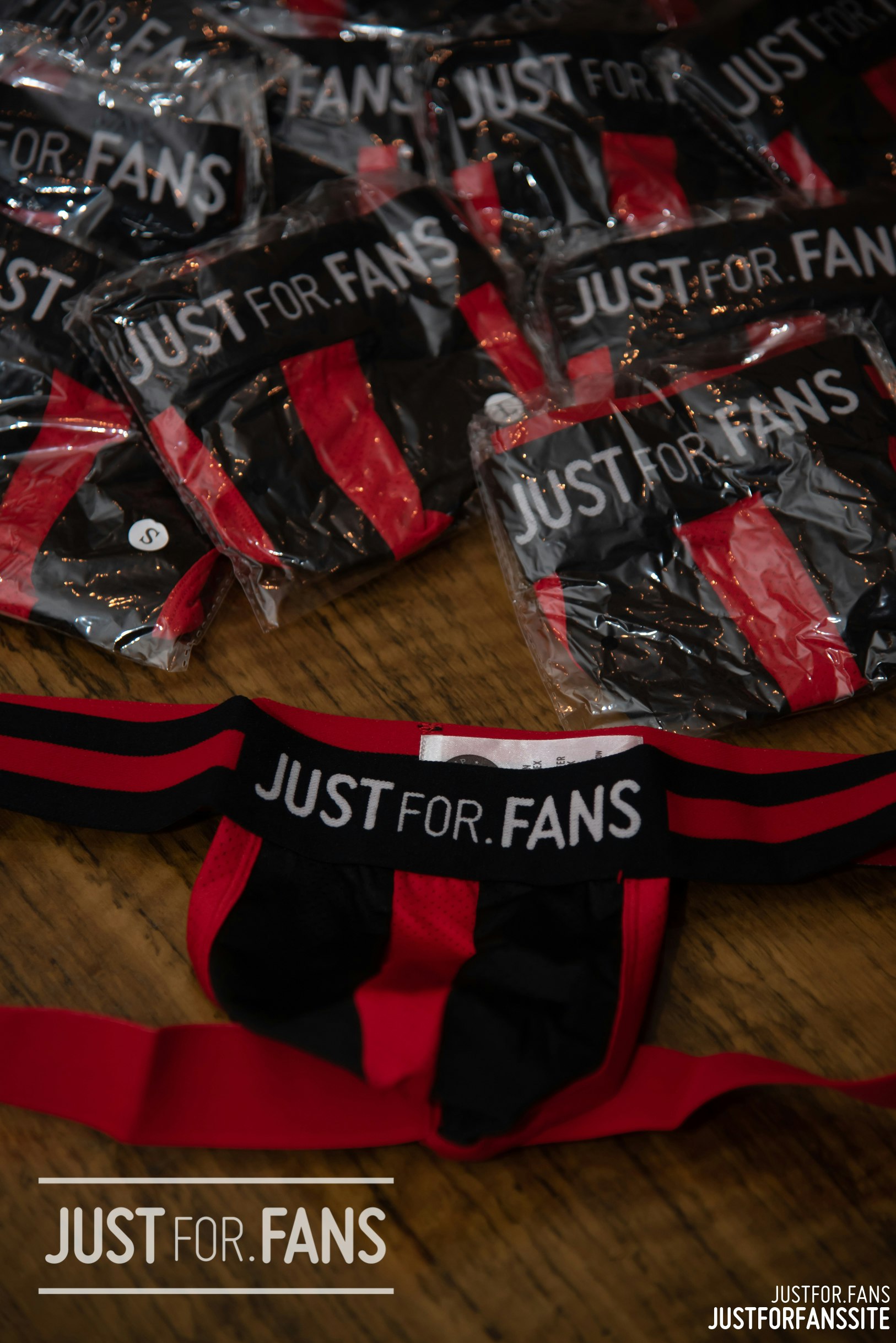 A pile of JustFor.Fans jock straps sit on a table - but aside from the merch, is it a good OnlyFans alternative?