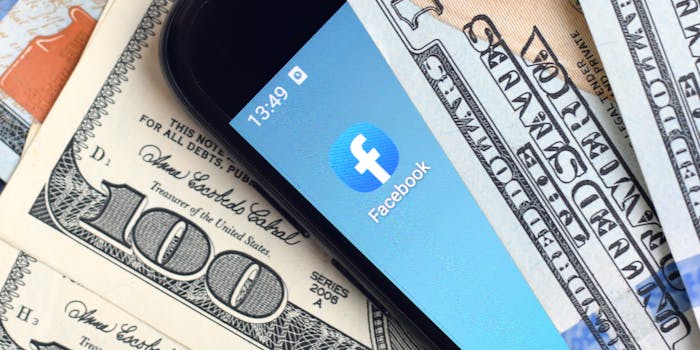 facebook app between hundred dollar bills. facebook agreed to pay a total of $650 million as part of a facial recognition lawsuit settlement.