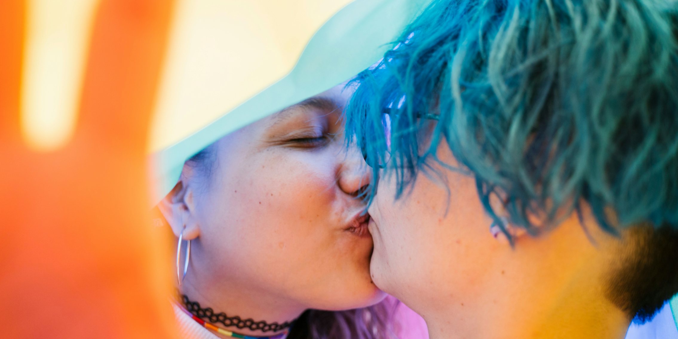 A close-up of two queer people kissing. Public displays of affection are often equated with public sex.