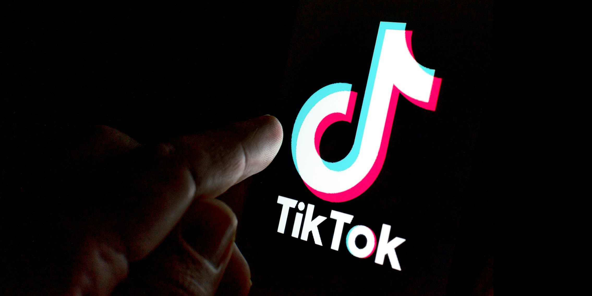finger reaching out to touch tiktok logo