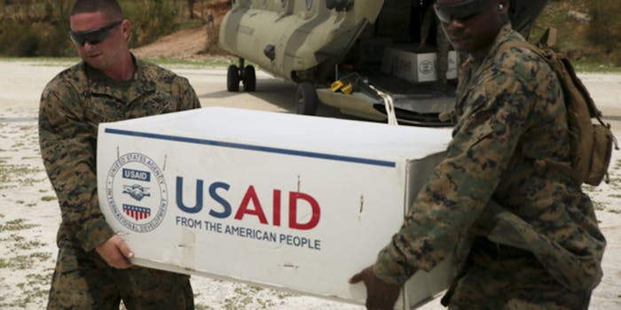 Soldiers holding a box with the USAID