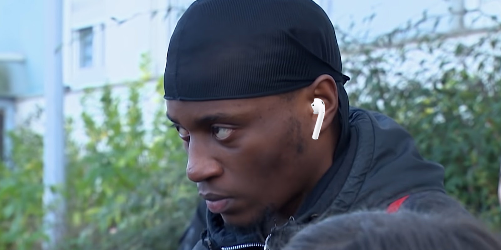 man staring intently wearing earpod