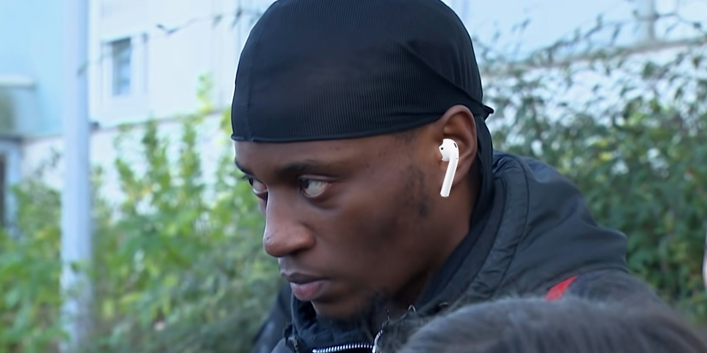man staring intently wearing earpod