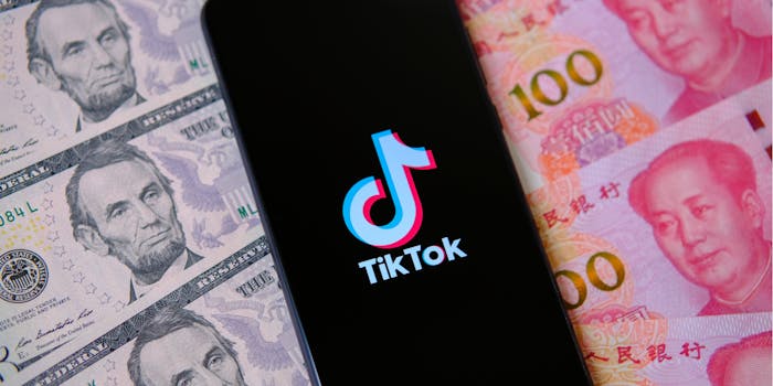 phone with tiktok icon over US and Chinese currency