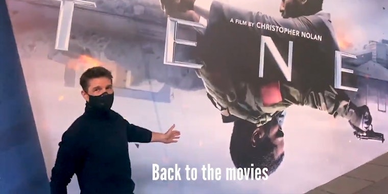 tom cruise in front of Tenet movie poster with 'Back to the movies' subtitle