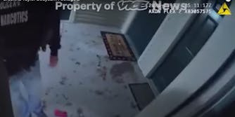 Bodycam footage shows an officer with a 'Narcotics' jacket standing on debris at Breonna Taylor's home