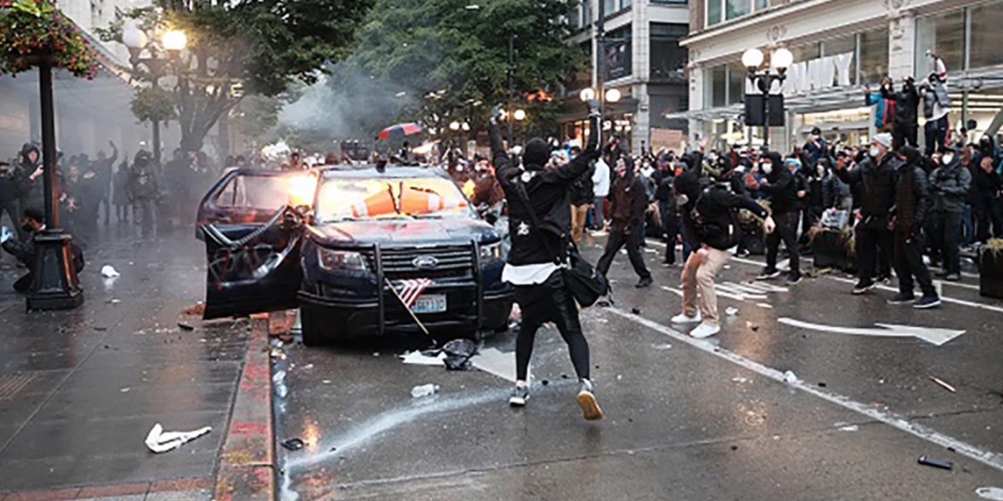 A police vehicle on fire during a protest