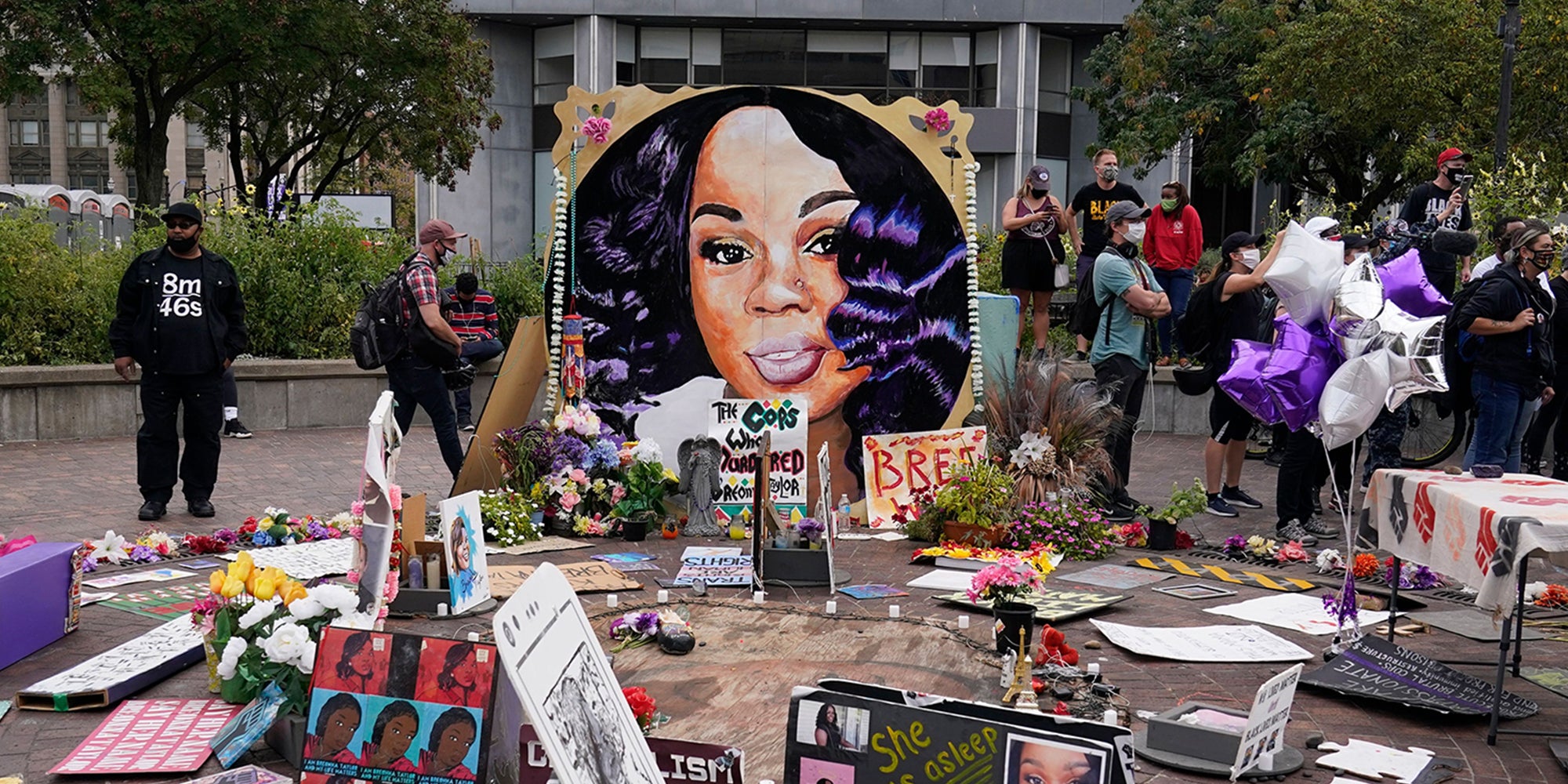 People gather in Jefferson Square around Breonna Taylor memorial