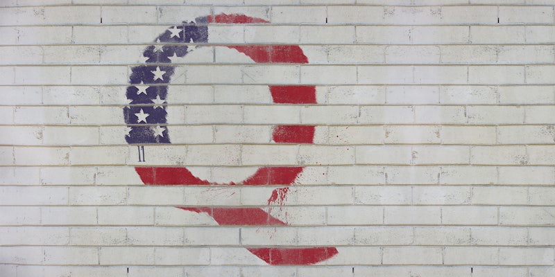 Q spray painted on wall in style of American flag