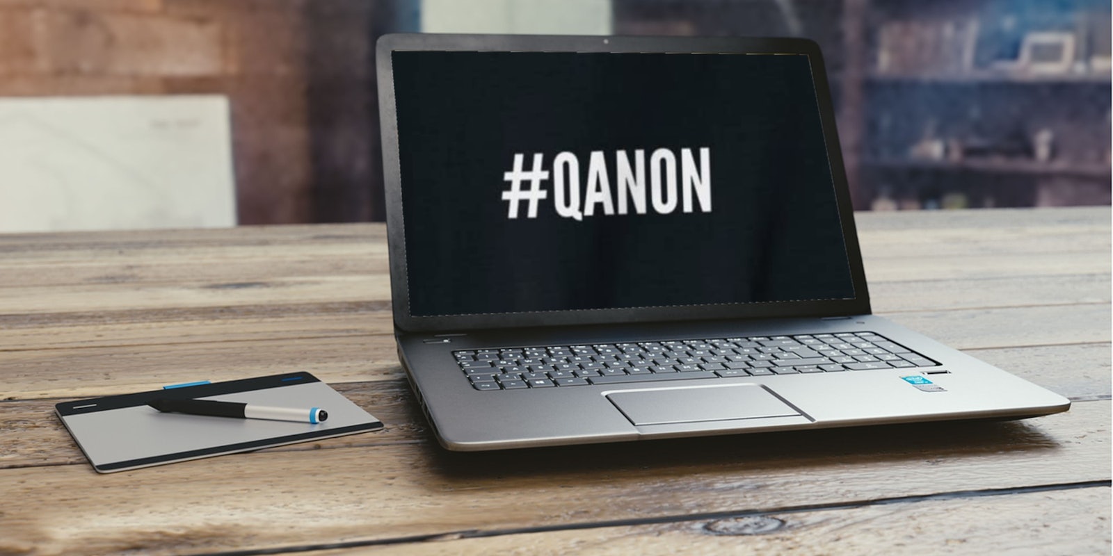 A laptop that says QANON on the screen