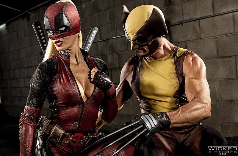 An image showing a woman dressed as a sexy Deadpool and a man dressed as Wolverine.