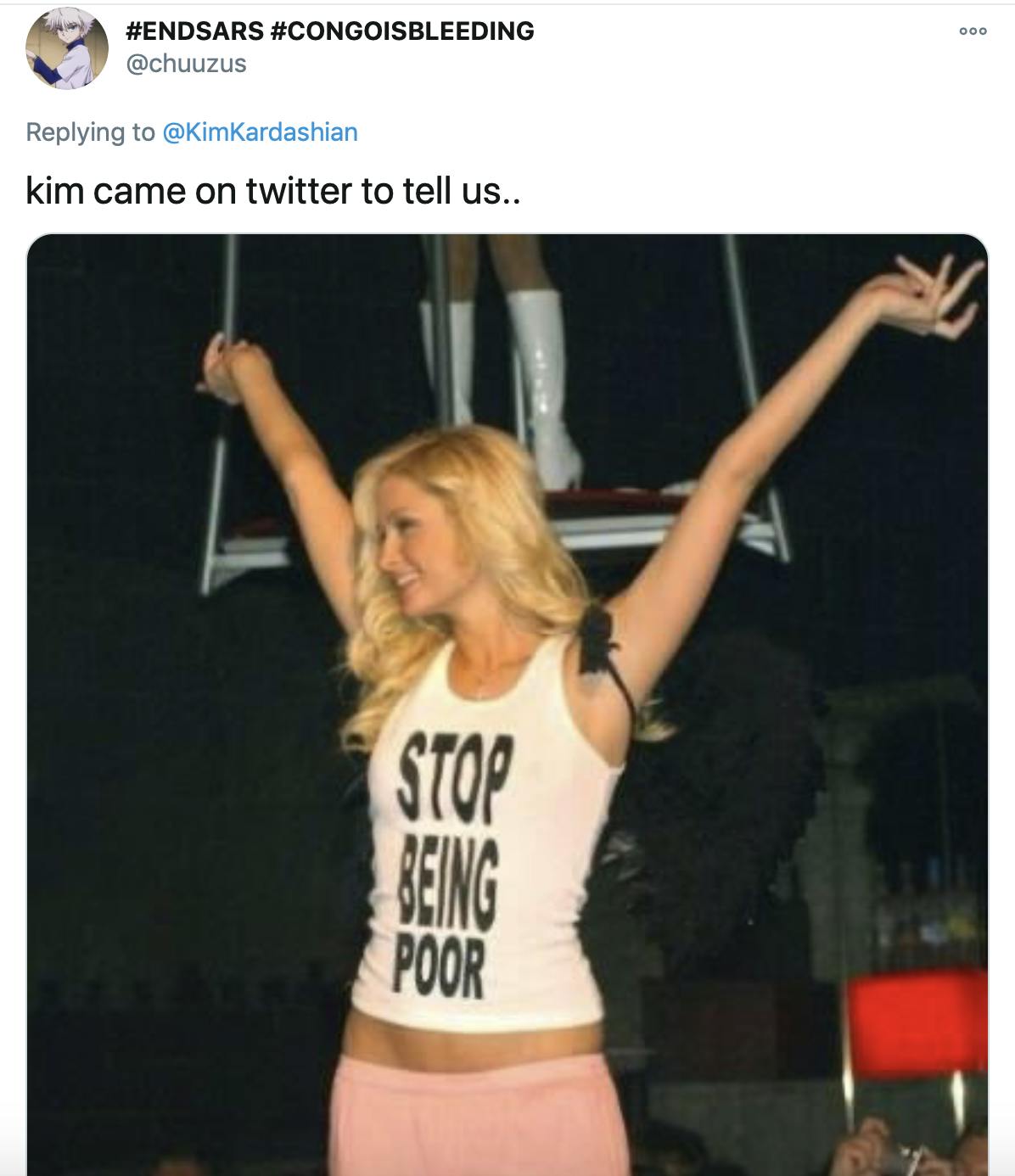 'kim came on twitter to tell us..' picture of Paris Hilton raising her arms in the air and smiling while wearing a long pink skirt and a white t-shit with 'stop being poor' on it in bold black letters