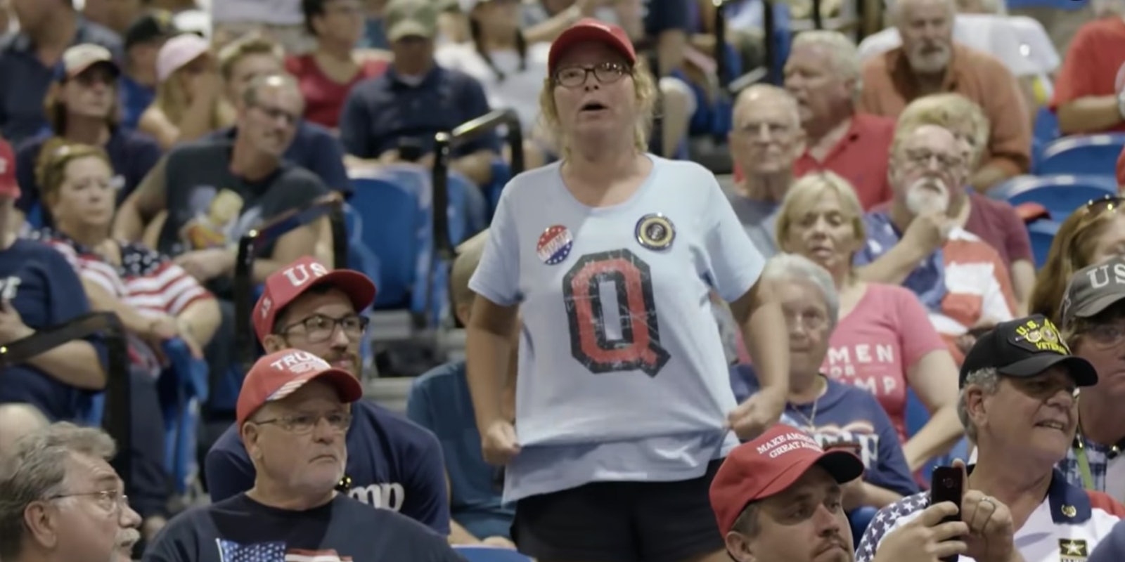 A woman wearing a QAnon t-shirt at a Trump rally