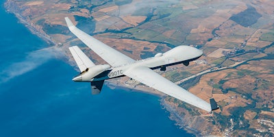 general atomics rebranded predator drone flies over coastline
