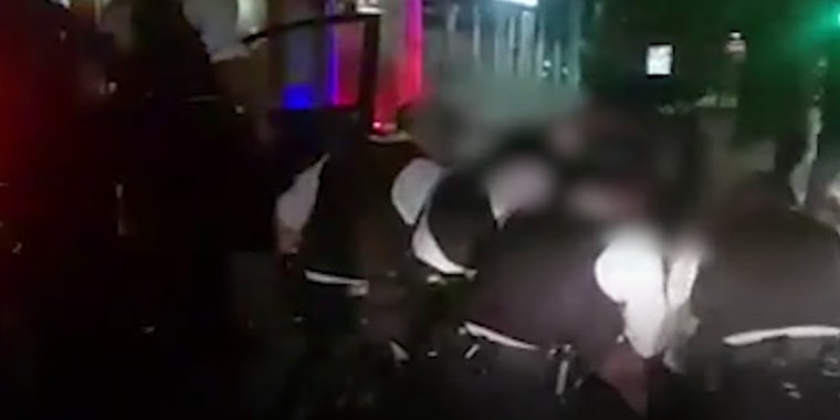 London police huddled over a Black woman screaming 'I can't breathe'