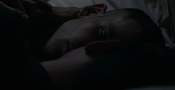 A hulu porn still from BPM showing two people lying close together