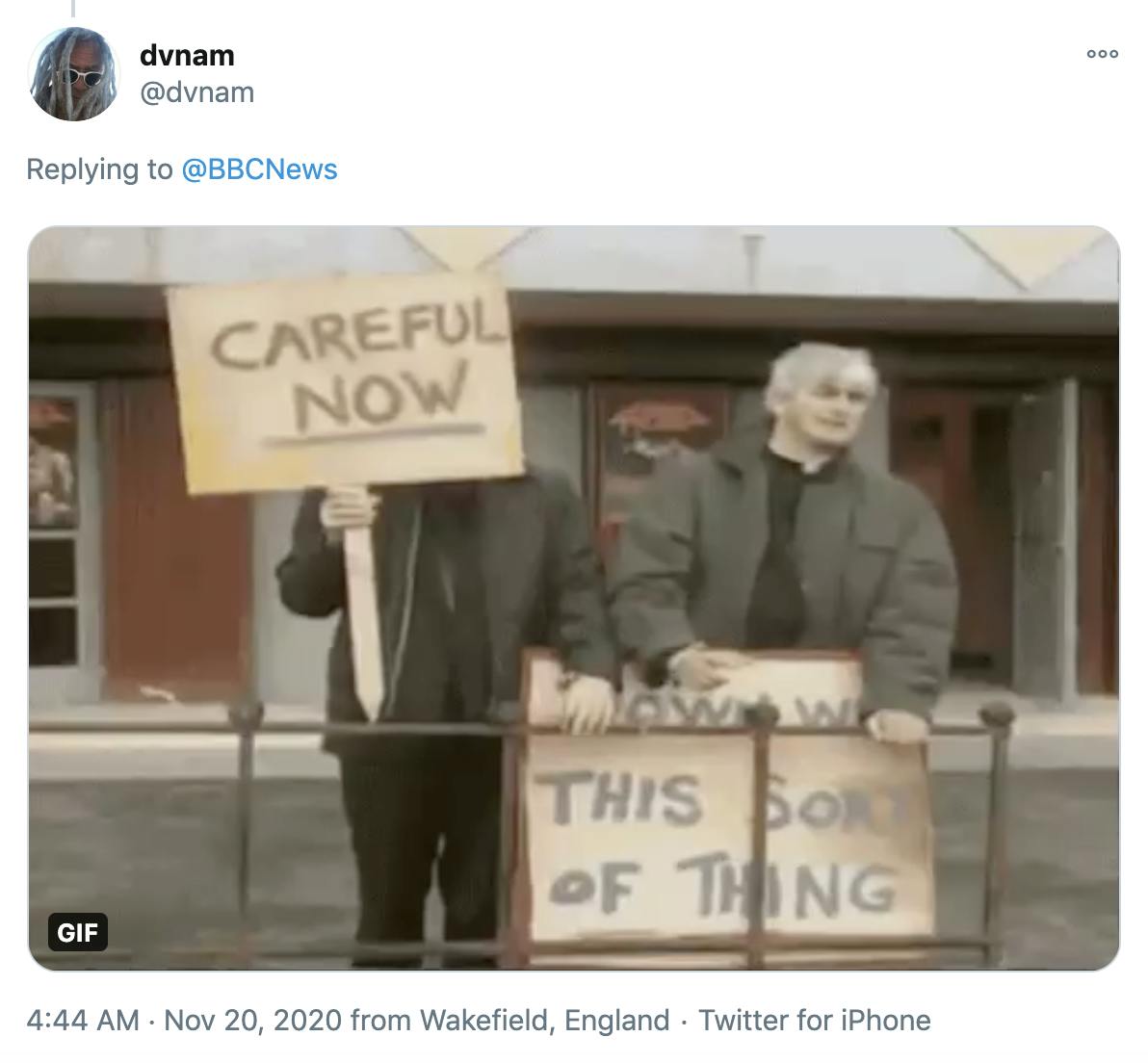 screenshot from Father Ted showing the two priests holding placards saying 'careful now' and 'down with this sort of thing'
