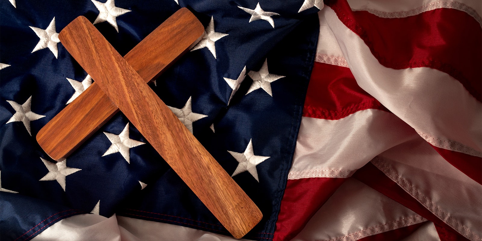 wooden cross on American flag