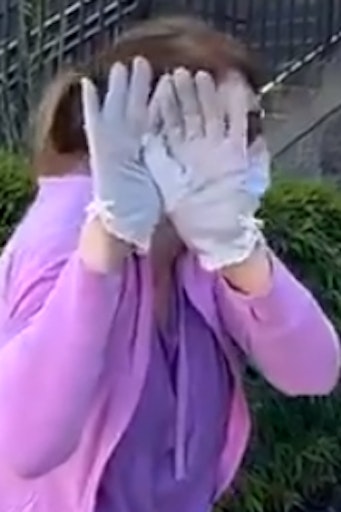 woman hiding her face behind her hands