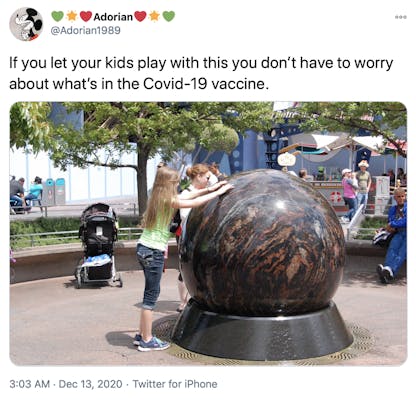 "If you let your kids play with this you don’t have to worry about what’s in the Covid-19 vaccine." a child with long blonde hair is touching a giant stone ball revolving in a fountain