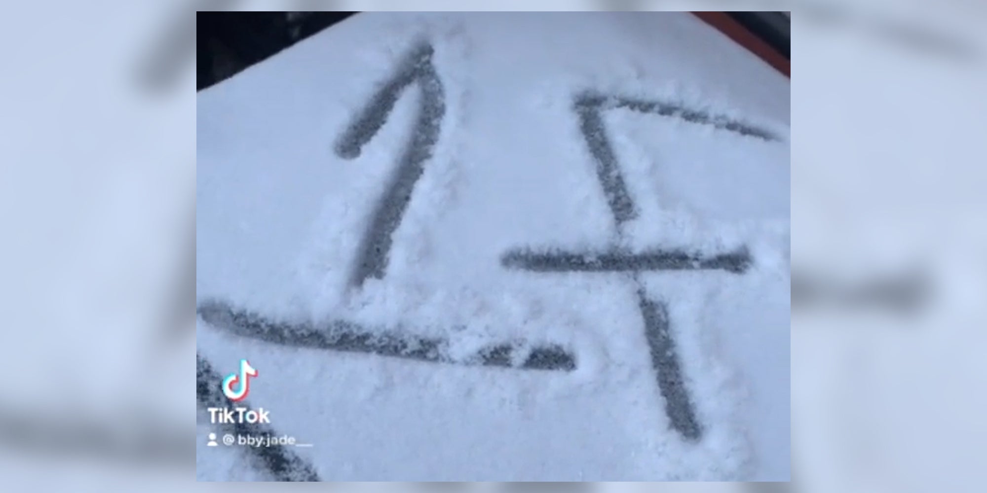 "1F" written in snow on top of a garbage can