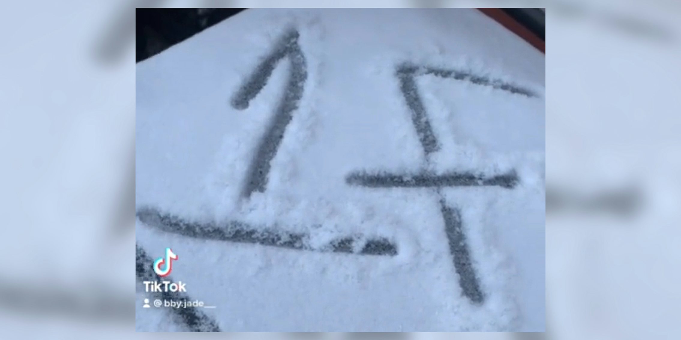 '1F' written in snow on top of a garbage can