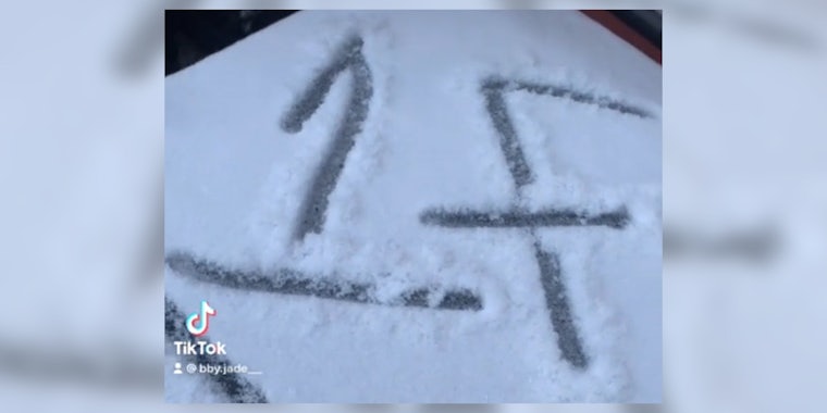 '1F' written in snow on top of a garbage can