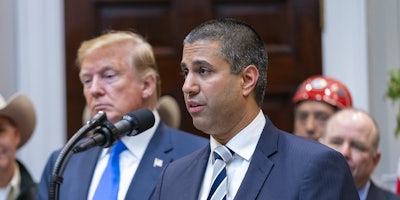 Ajit Pai standing next to President Donald Trump. Pai said the FCC won't take up Trump's Section 230 executive order.