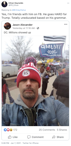 "Yes, I’m friends with him on FB. He goes HARD for Trump. Totally uneducated based on his grammar." Photograph of Jason Alexander wearing a red ad white '45' bobble hat and a jean jacket, taken at the Capitol Hill riots with flag waving rioters behind him