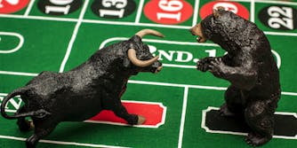 Bull and bear figurines on roulette table