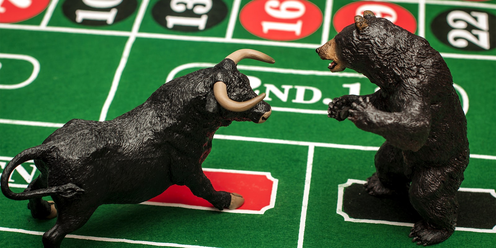 Bull and bear figurines on roulette table
