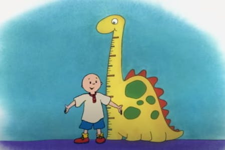 Photo of Caillou standing next to a dinosaur, showing his tall height.