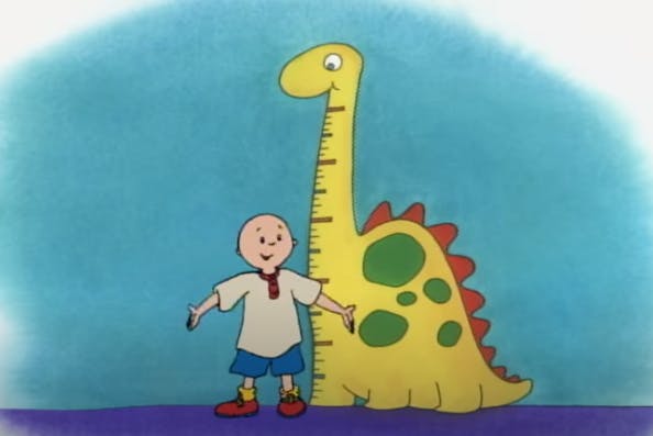 photo of caillou next to a dinosaur