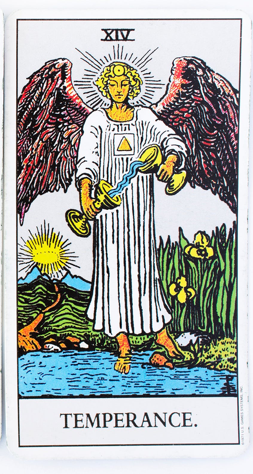 temperance card from the rider-waite deck. image of an angle pouring water from one cup to another.