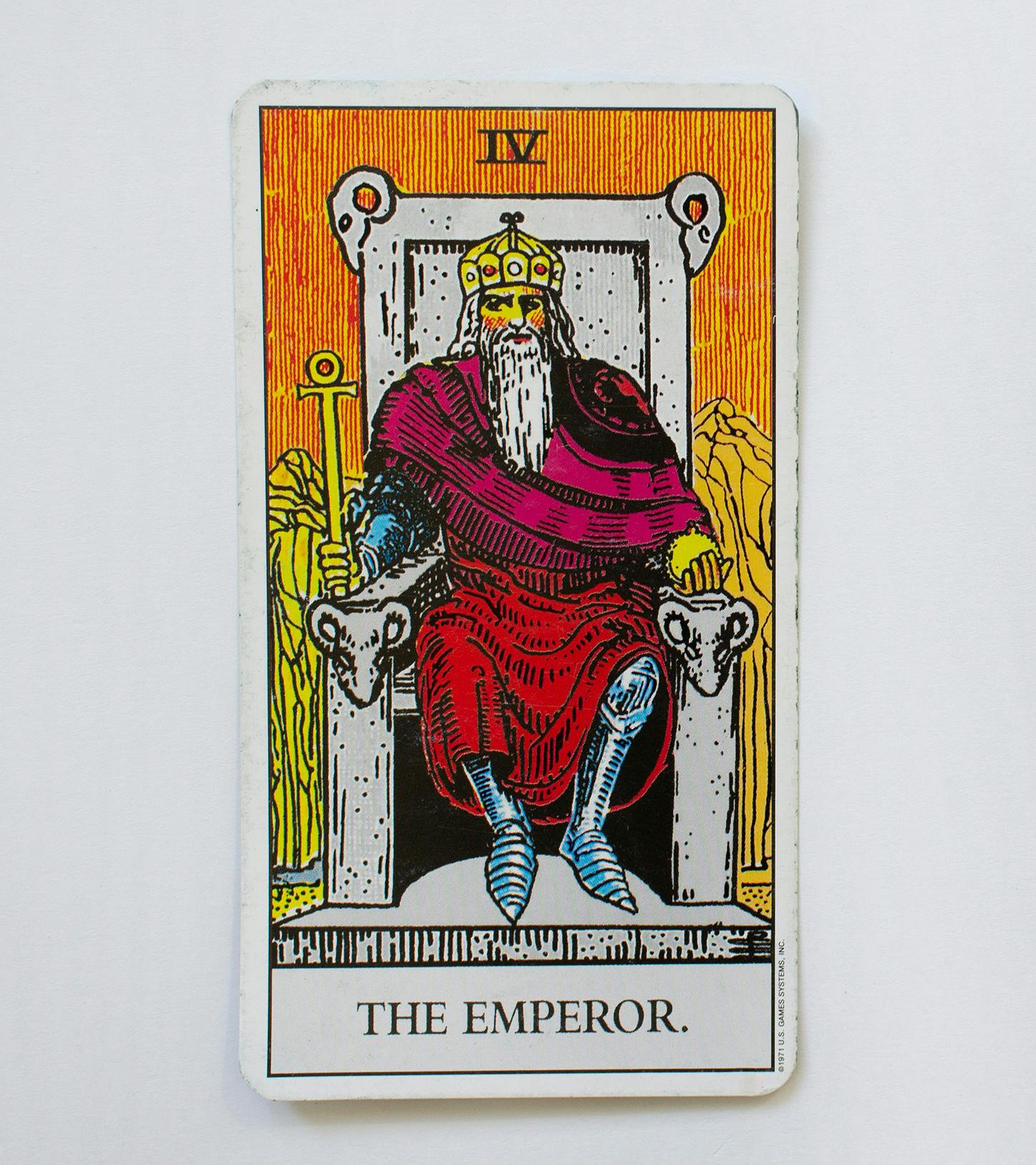 The emperor card. Features a man sitting in a throne wearing a red cape and holding a scepter.