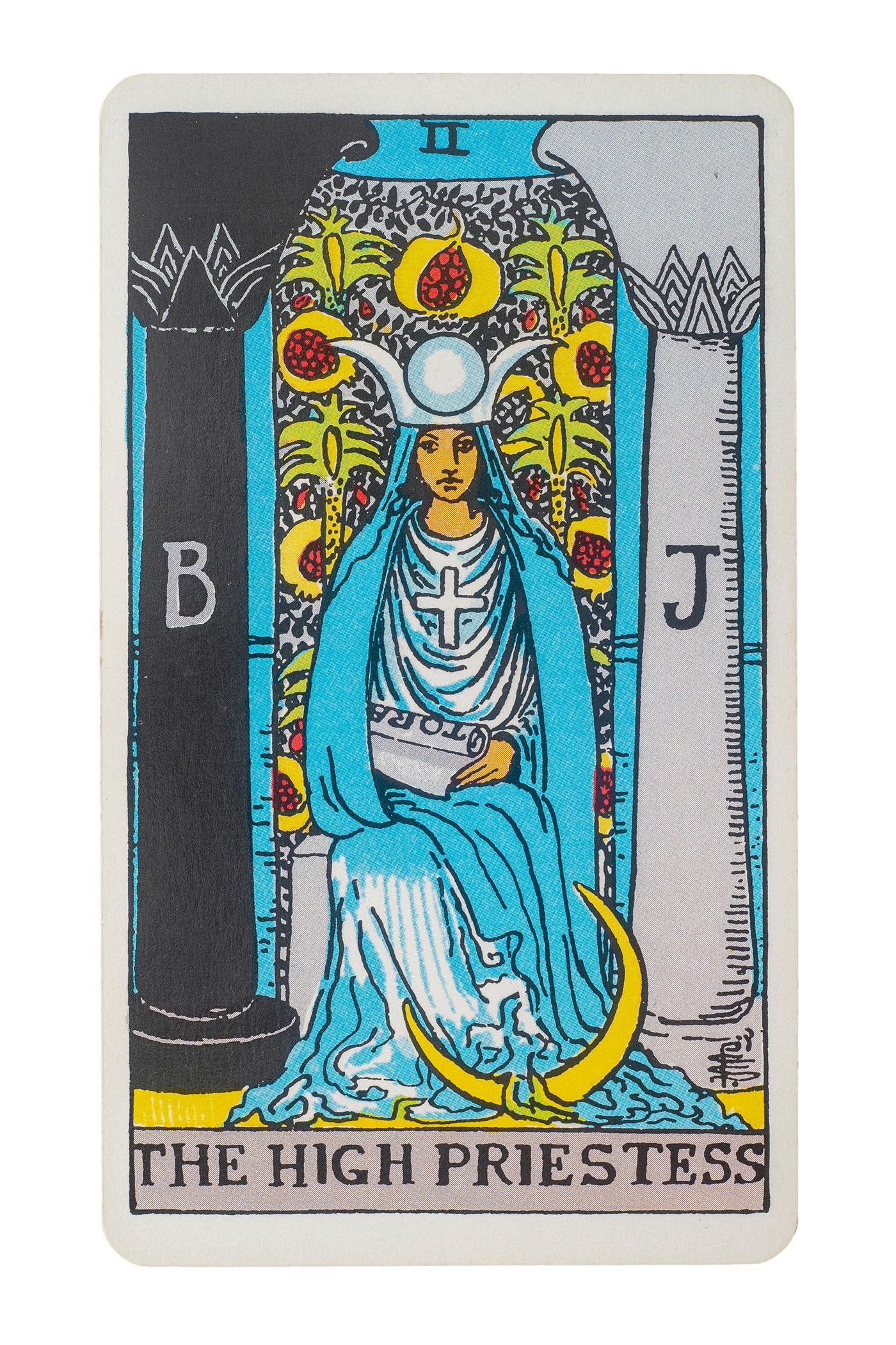 The High Priestess card. Features a women sitting in between two pillars with the moon at her feet.